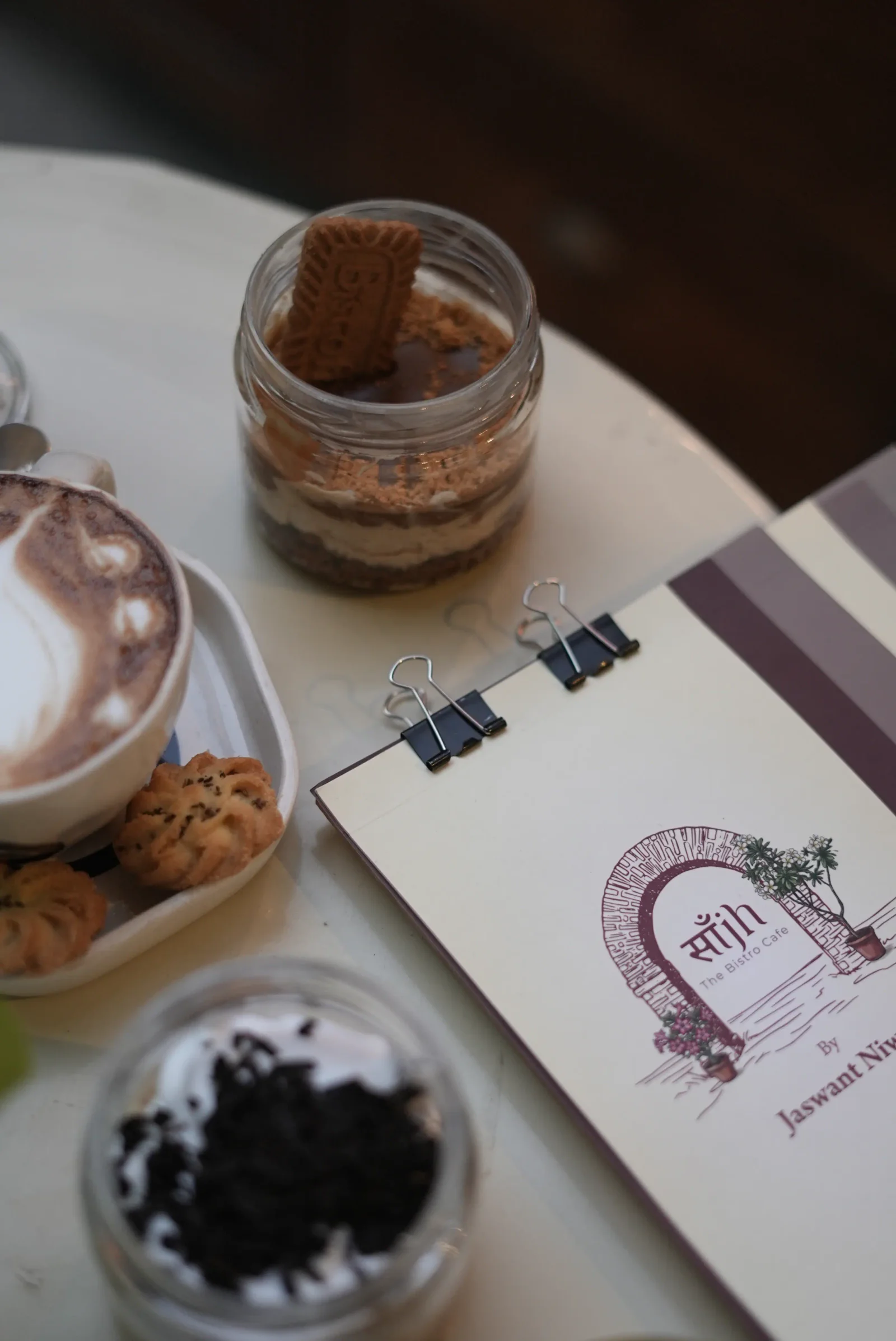 A layered dessert jar finished with a Lotus Biscoff biscuit at Saanjh The Bistro, Jodhpur