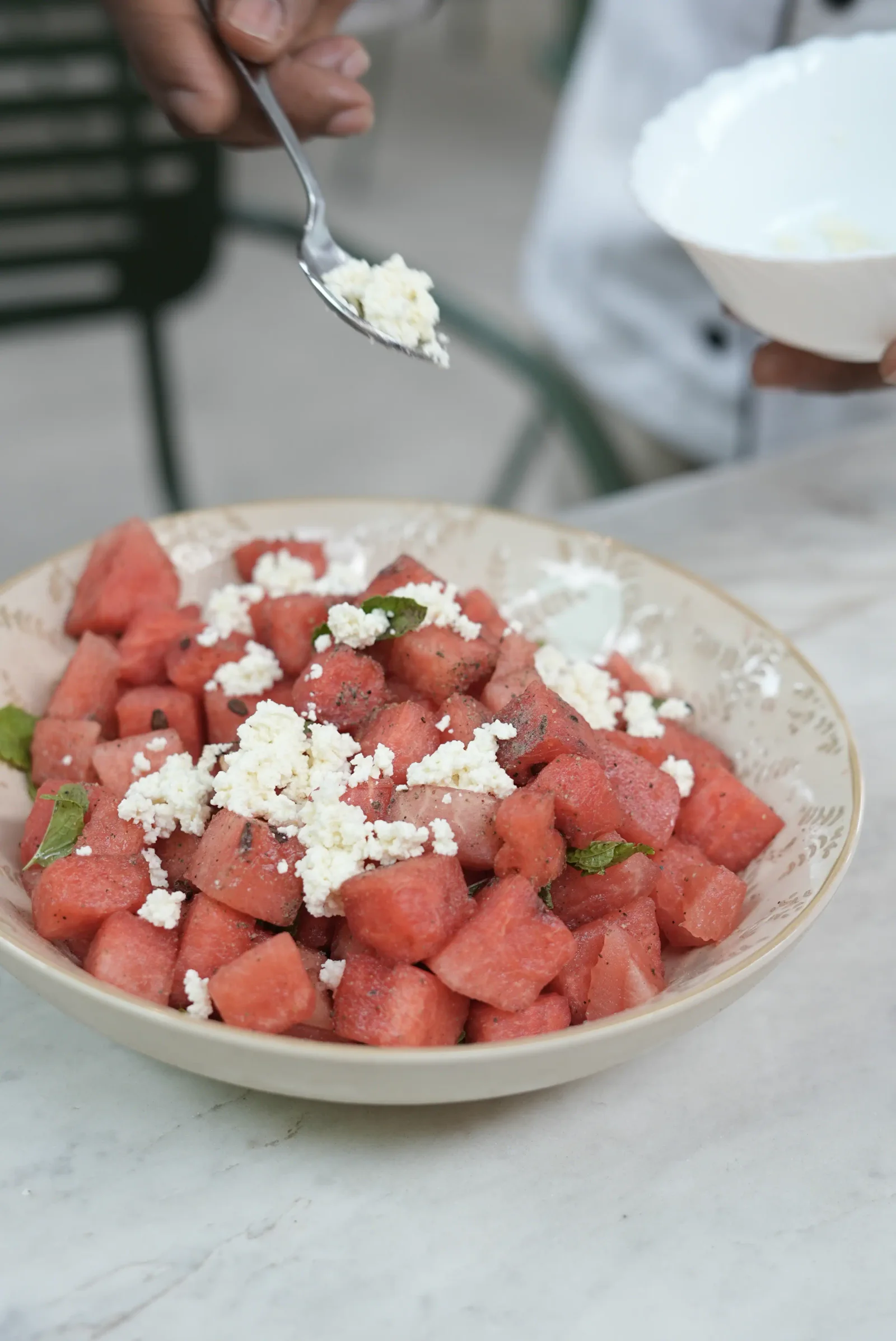A bowl of cubed watermelon scattered with crumbled feta and mint at Saanjh The Bistro, Jodhpur